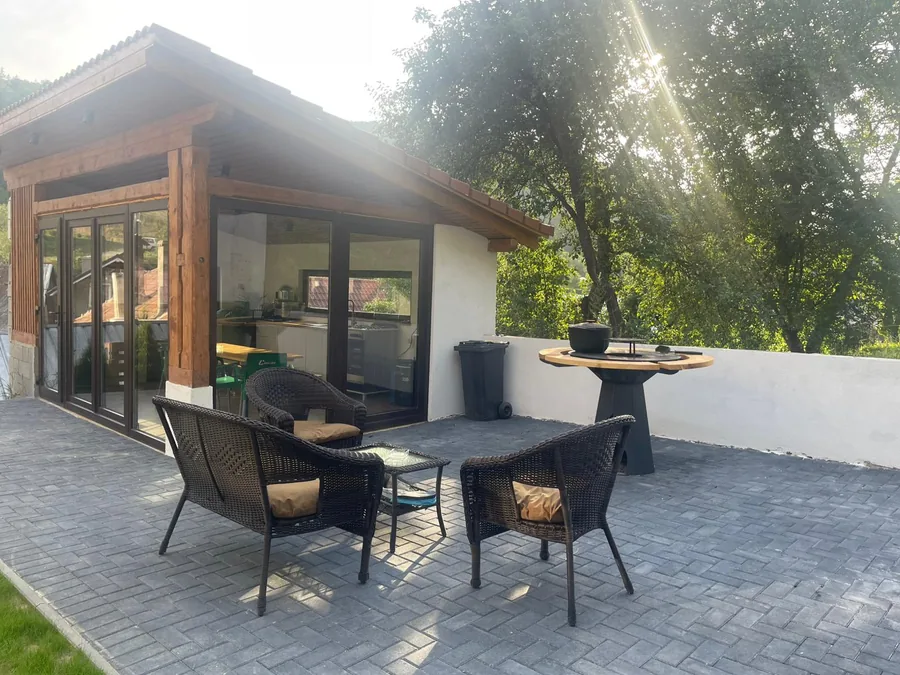Gazebo at sunset — lounge area with wicker armchairs
